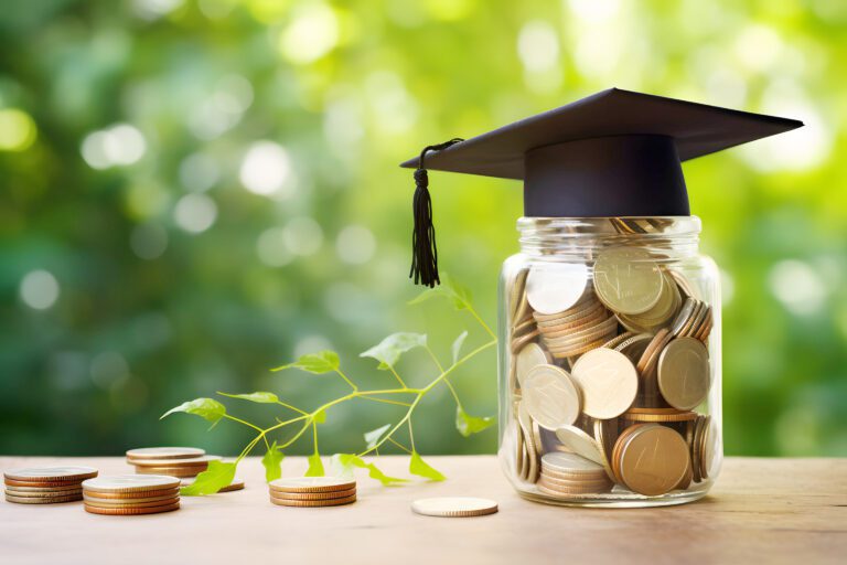 A graduation cap sitting on top of a jar filled with coins